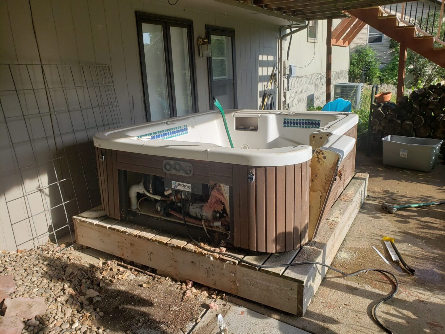 A hot tub is being built in the back yard.