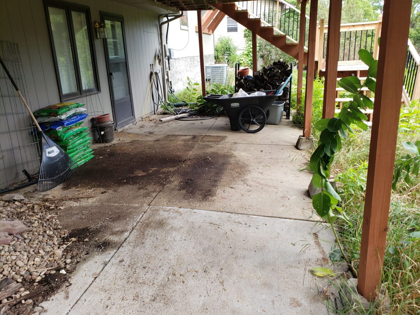 A patio with a man sitting on the back of it.